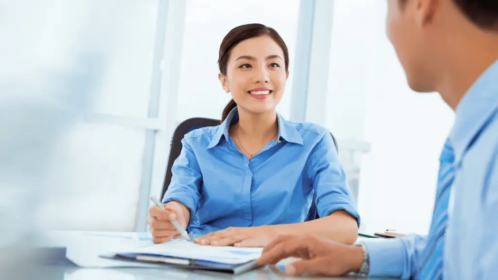 Woman smiling at her coworker as they talk in a meeting—Stratice blog cover.