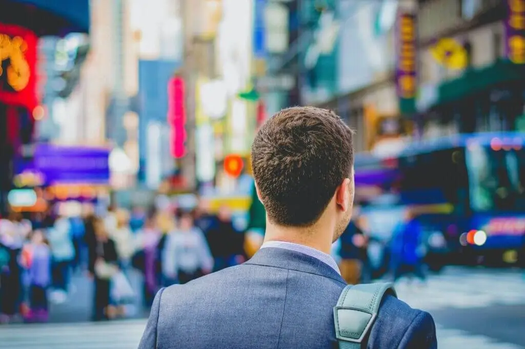 A man walking through Times Square. Stratice blog cover.