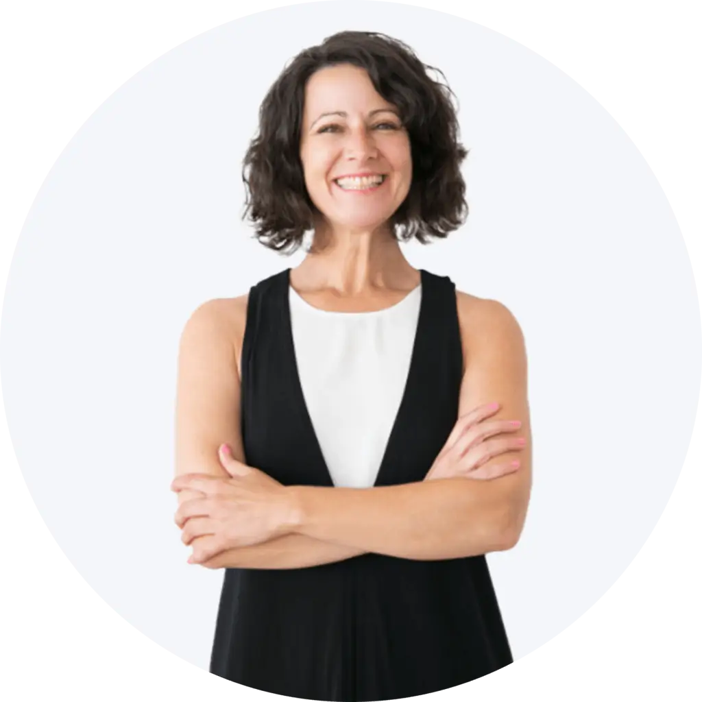 A middle-aged woman with short brown hair, stands with her arms folded in a professional headshot.